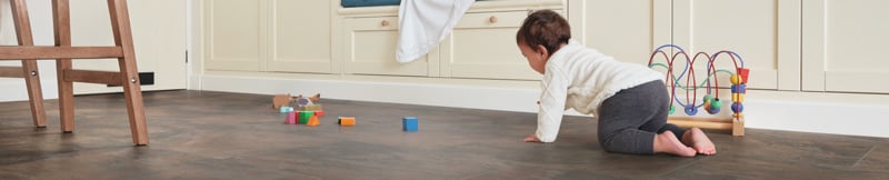 Baby crawling in a kitchen on Antique Copper  RKT3002-G floors