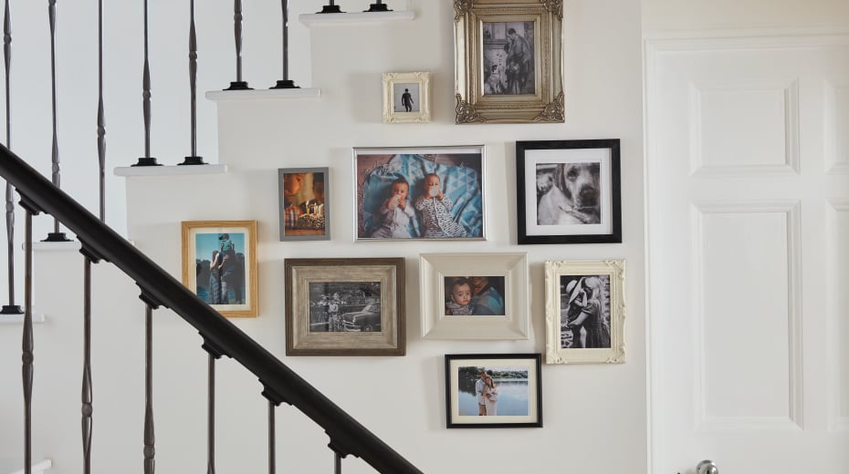 Stairwell with collage of family photos on the wall