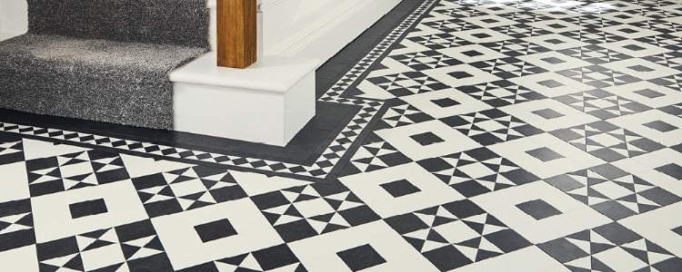 Entryway floor with Clifton black and white tiles and white stairs with gray carpet tred